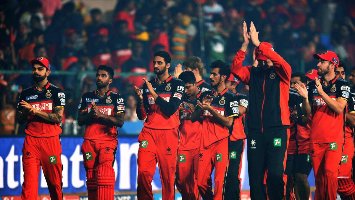 Royal Challengers Bangalore captain Virat Kohli (L) and his teammates acknowledge supporters after losing against Sunrisers Hyderabad in the final Twenty20 cricket match of the 2016 Indian Premier League (IPL) between Royal Challengers Bangalore and Sunrisers Hyderabad at The M Chinnaswamy Stadium in Bangalore on May 29, 2016. - AFP