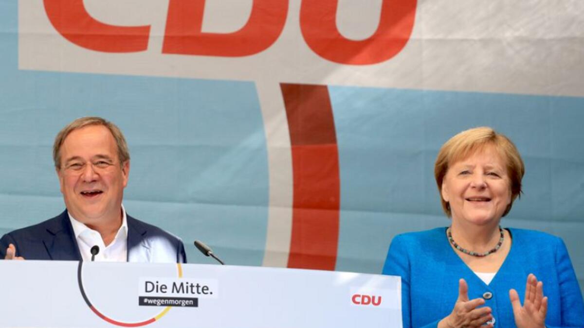 German Chancellor Angela Merkel and Christian Democratic Union (CDU) party leader and candidate for chancellor, Armin Laschet, attend an election rally. Photo: Reuters