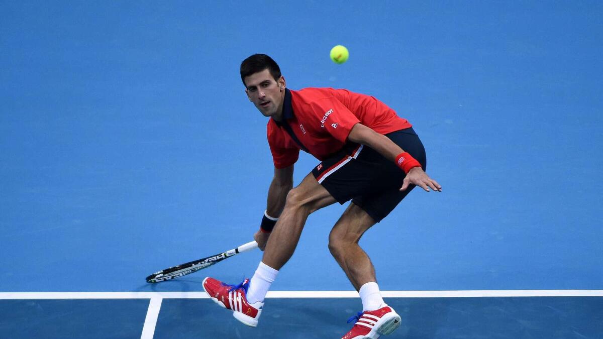 Novak Djokovic of Serbia hits a return against Zhang Ze of China during their men's singles second round match at the China Open tennis tournament in Beijing on October 8, 2015.  