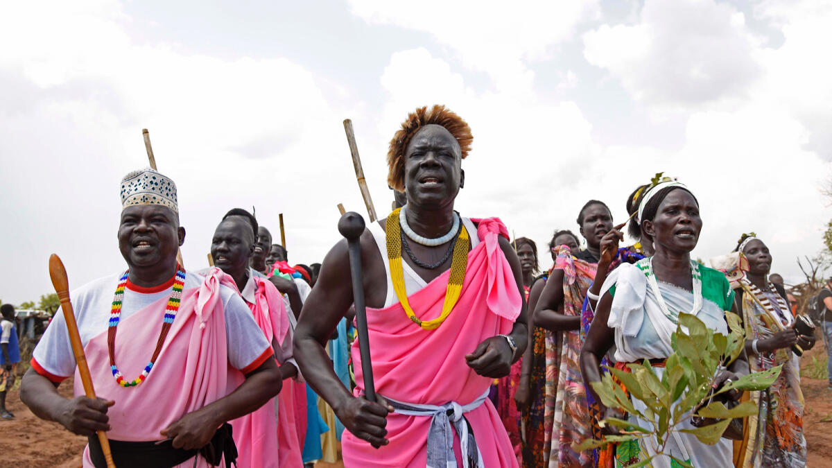South Sudanese refugees perform a traditional dance as the United Nations High Commissioner for Refugees visits the newly created Pagirinya refugee settlement in Adjumani, north of the capital Kampala on August 29, 2016.AFP