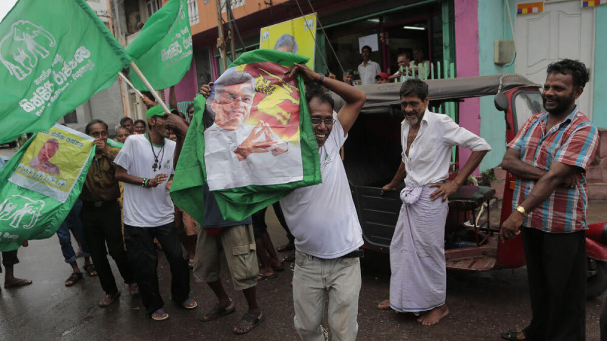 Supporters of Sri Lanka's ruling United National Party carry a portrait of prime minister Ranil Wickremasinghe as they celebrate their party's election performance in Colombo.