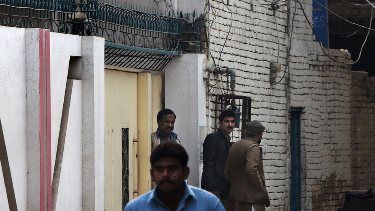 Pakistani investigators leave the house of Gulzar Ahmed Malik, the father of female US shooter Tashfeen Malik, in Multan.