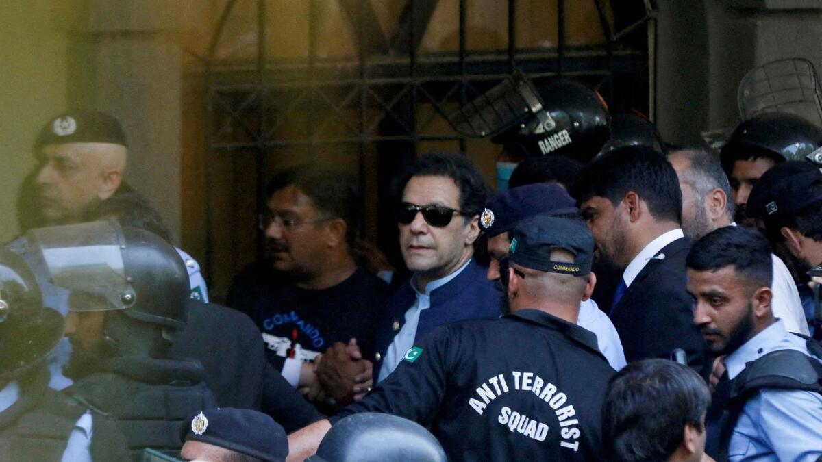 Security officers escort Pakistan's former prime minister Imran Khan as he appeared in Islamabad High Court, Islamabad, Pakistan, on May 12, 2023. -- Reuters file
