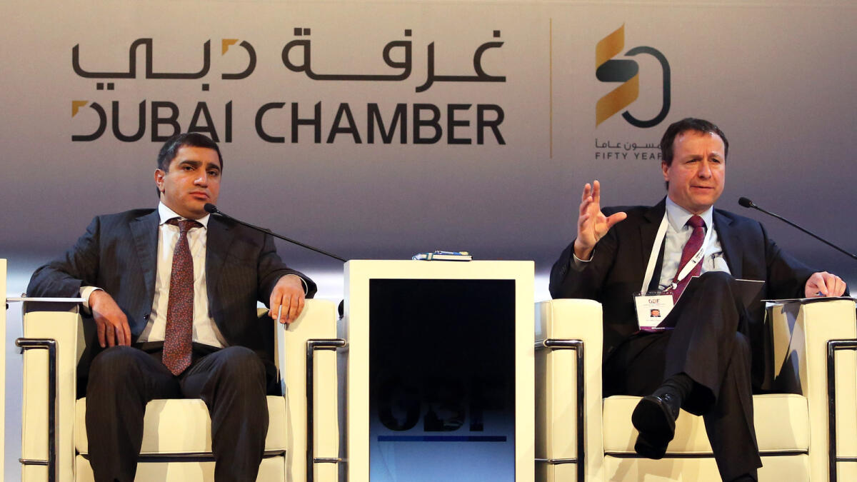 Suhail bin Mohammed Faraj Al Mazroui and Majid Saif Al Ghurair attend the first day of the inaugural CIS Global Business Forum in Dubai on Wednesday; (right) Ruslan Alikhanov and Jean-Marc Peterschmitt participate in a panel discussion on the reorientation of CIS businesses. — Photos by Dhes Handumon