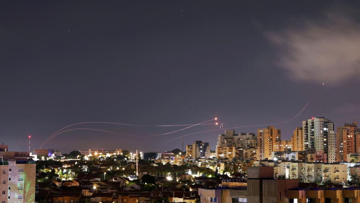 Streaks of light are seen as Israel's Iron Dome anti-missile system intercept rockets launched from the Gaza Strip, as seen from the city of Ashkelon. — REuters