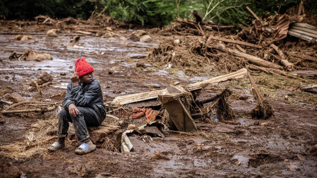 A man looks on in a muddy area heavily affected by torrential rains and flash floods in the village of Kamuchiri, near Mai Mahiu, on Monday.  — AFP