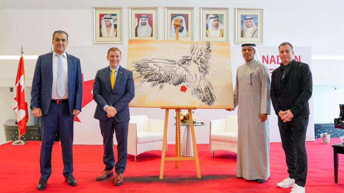 Professor Karim Chelli, president and vice-chancellor, CUD, Dr Andrew Furey, premier of the province of Newfoundland and Labrador and Buti Saeed Al Ghandi, chancellor, CUD with the artwork representing the deep-rooted connections between Canada and the UAE.
