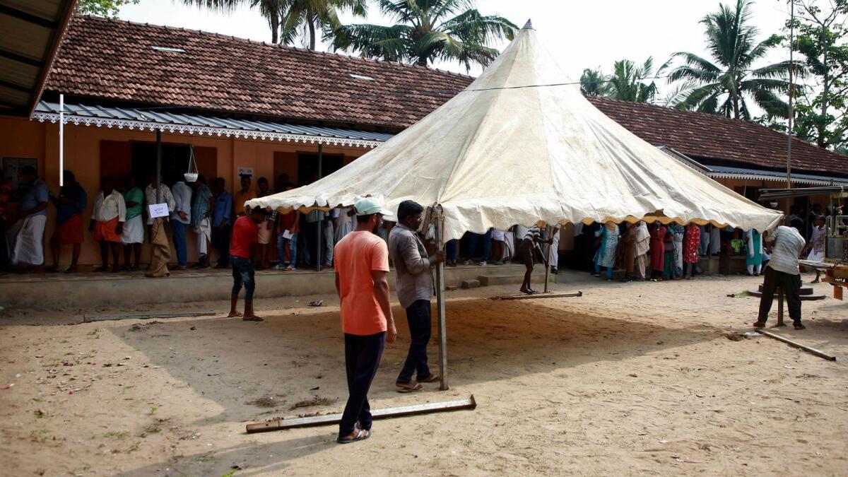 Workers erect a tent to provide shade for voters on a hot summer day, at a polling station during the second phase of the general election, in Eramalloor village in Kerala on April 26. Photo: Reuters