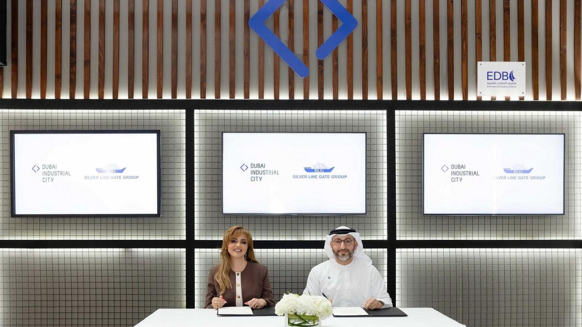 Shereen Saeed, general manager at SLG Group, and Saud Abu Alshawareb, executive vice- president of Industrial Leasing – Tecom Group, signing the contract. — Supplied photo