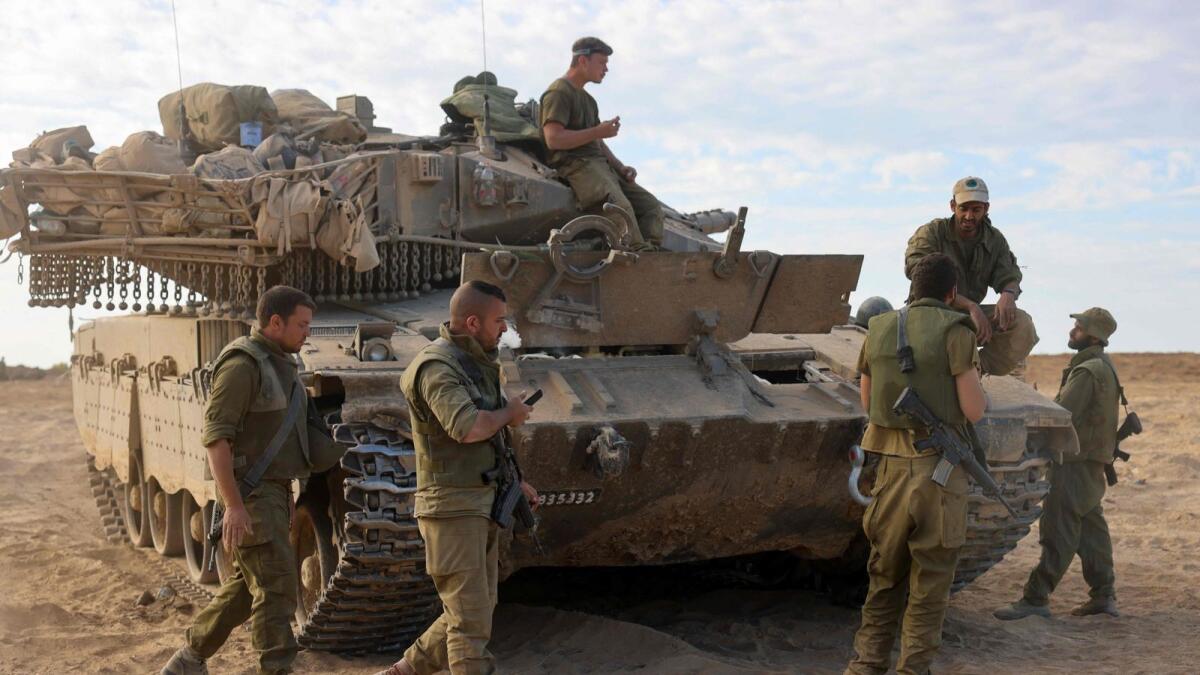 Israeli soldiers deploy near the border with Gaza on Tuesday. — AFP
