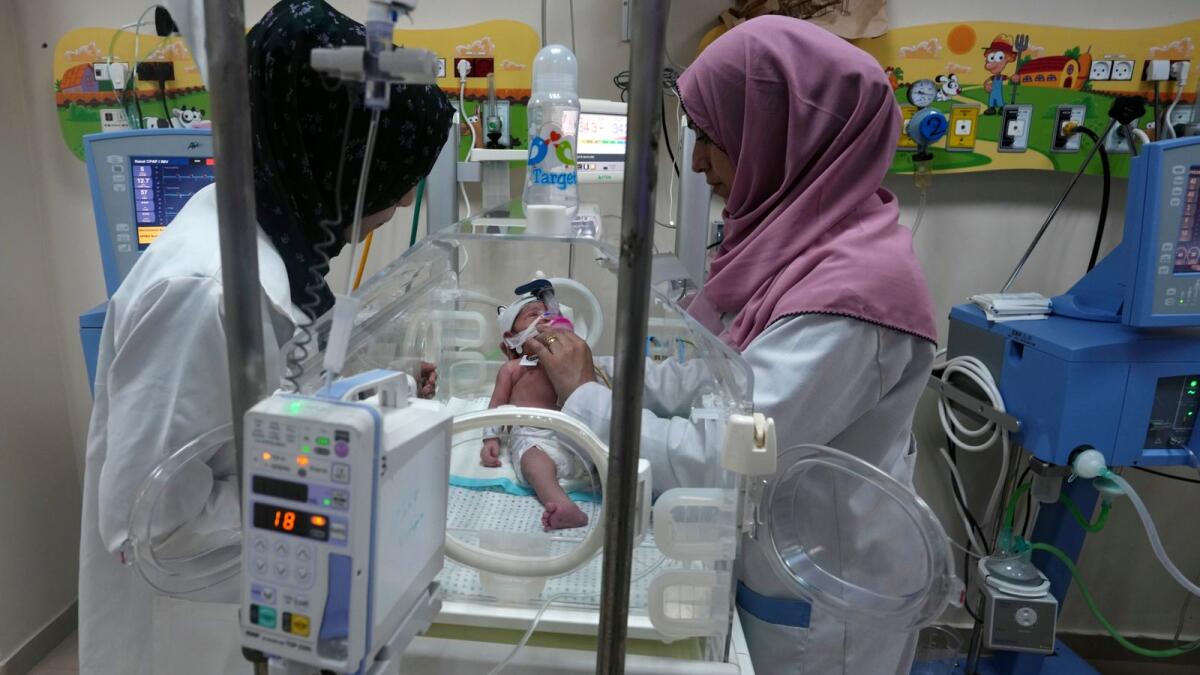 Palestinian doctors treat a prematurely born baby at Al Aqsa Hospital in Deir El Balah, Gaza Strip, on Sunday. — AP