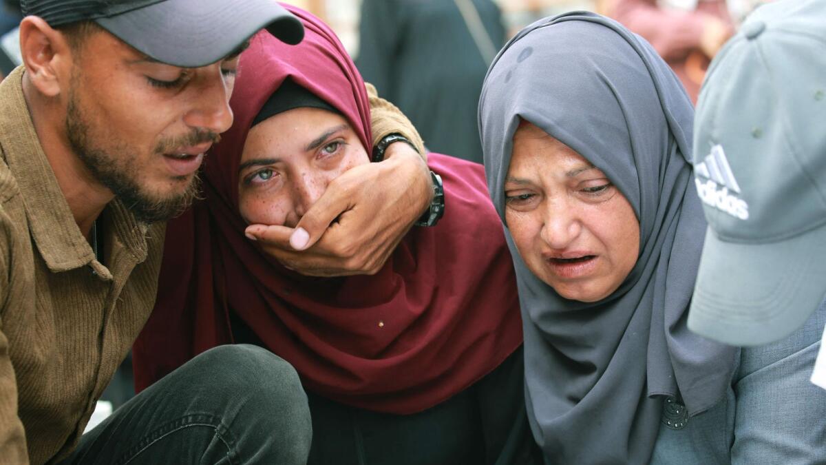 Palestinians grieve as they bid farewell to a relative, the day after a strike on the al-Mawasi area, northwest of the Palestinian city of Rafah on Saturday. Photo: AFP