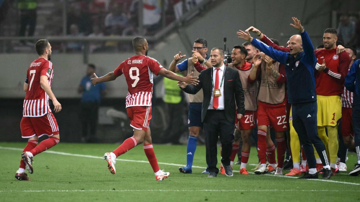 Olympiakos' Moroccan striker Ayoub el-Kaabi (2L) runs to celebrate with teammates after scoring Olympiakos' second goal during the UEFA Europa Conference League semi final against Aston Villa. - AFP