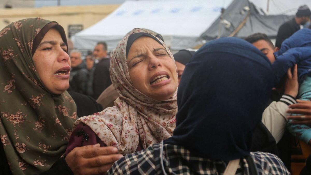 Women mourn after the death of relatives in an Israeli air strike that hit the Baraka family home in Deir al-Balah in the central Gaza Strip. Photo: AFP
