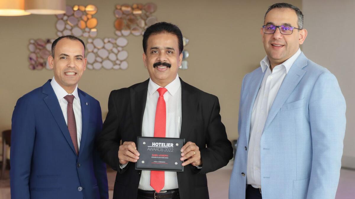 Sabu Joseph, banquet operations manager of Crowne Plaza Hotel Deira, has been selected as 'Highly Recommended Banquet Manager of the year 2022' during the Hotelier Middle East Awards. In the photo from left: Emad Ramzy, general manager at Crowne Plaza Dubai Deira, Sabu Joseph, and Joseph Karam, director of operations at Ishraq Hospitality.