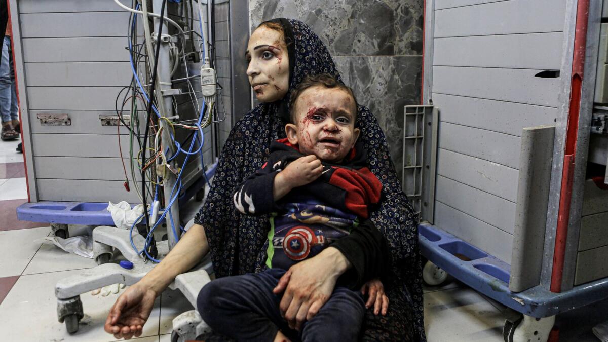 Wounded Palestinians wait for treatment at Al Shifa hospital in Gaza City on Tuesday. — AP