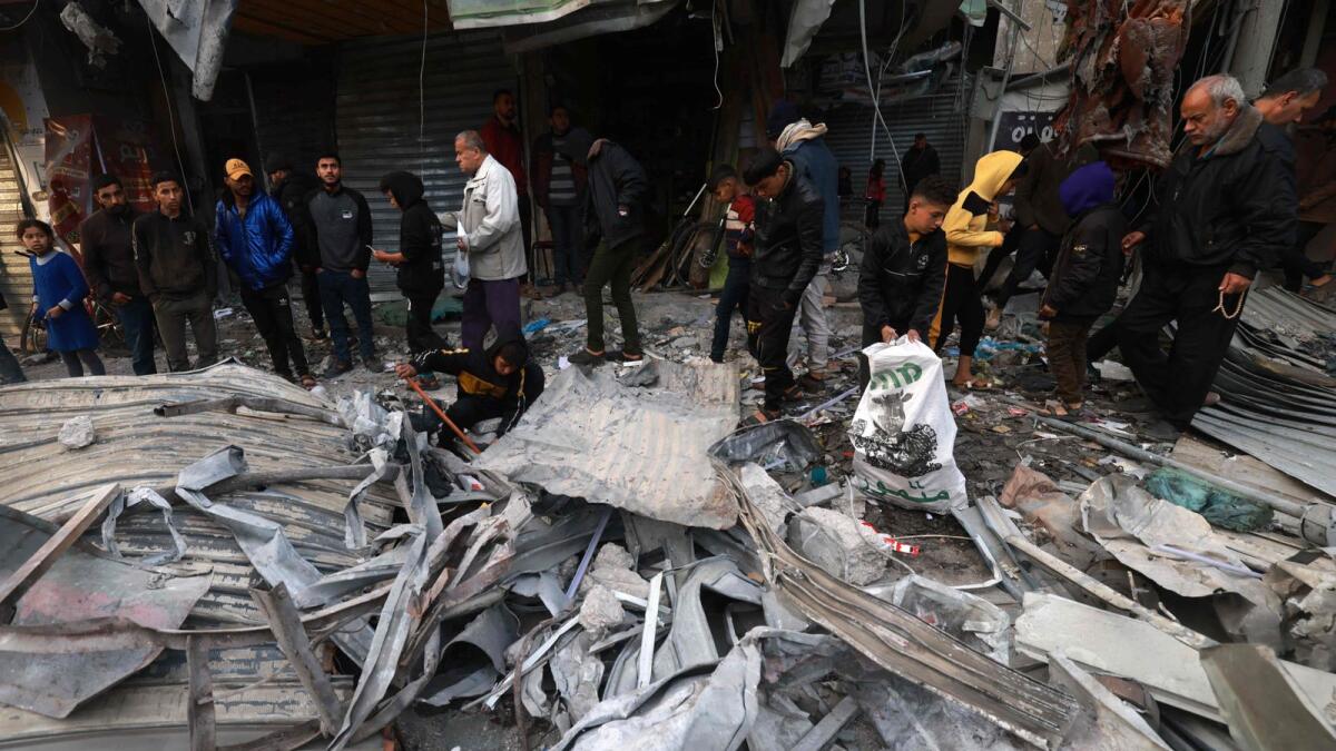 Palestinians inspect the debris of a house destroyed by Israeli bombing in Rafah. Photo: AFP