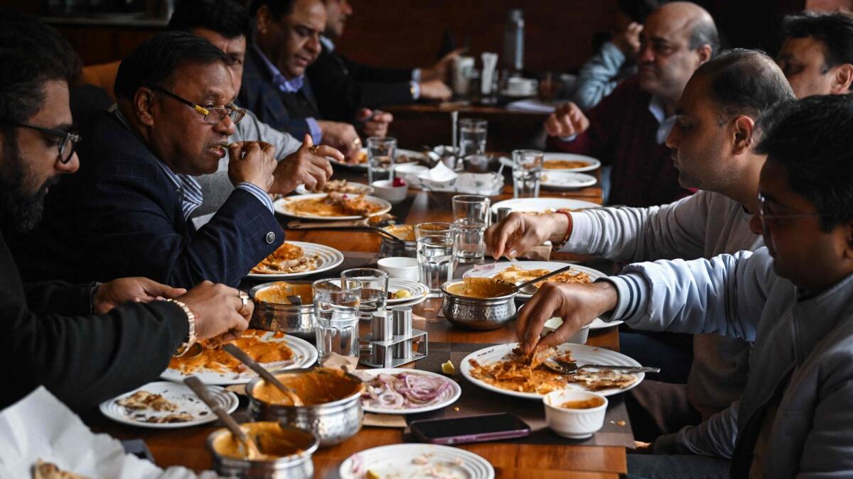 People eat butter chicken at the Moti Mahal restaurant in New Delhi. Photo: AFP file