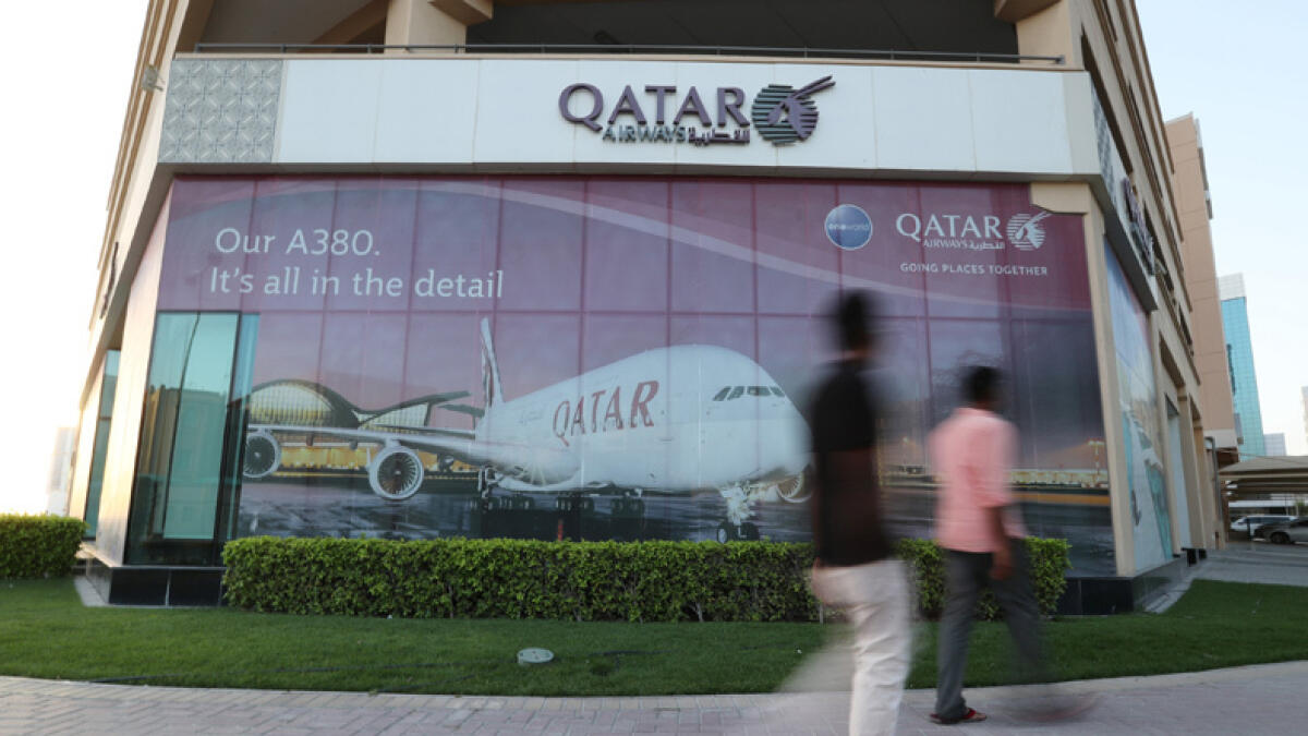 Passengers of cancelled flights wait at Hamad International Airport in Doha, Qatar. 