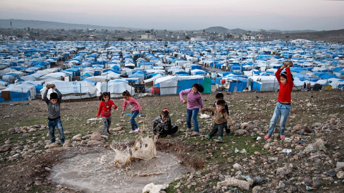 Syrian refugee children play at a temporary refugee camp in Irbil, northern Iraq.