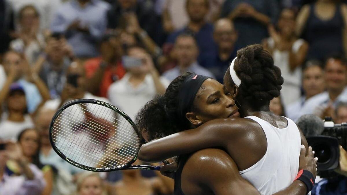 Serena Williams of the U.S. (L) embraces her sister and compatriot Venus Williams after defeating her in their quarterfinals match at the U.S. Open Championships tennis tournament in New York, September 8, 2015. 