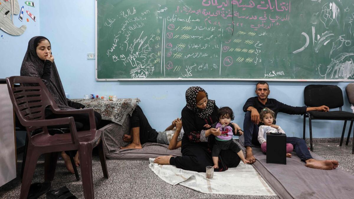 Photo: Palestinians fleeing Israeli air strikes take refuge in a school run by the United Nations  in Gaza City on October 8, 2023. AFP