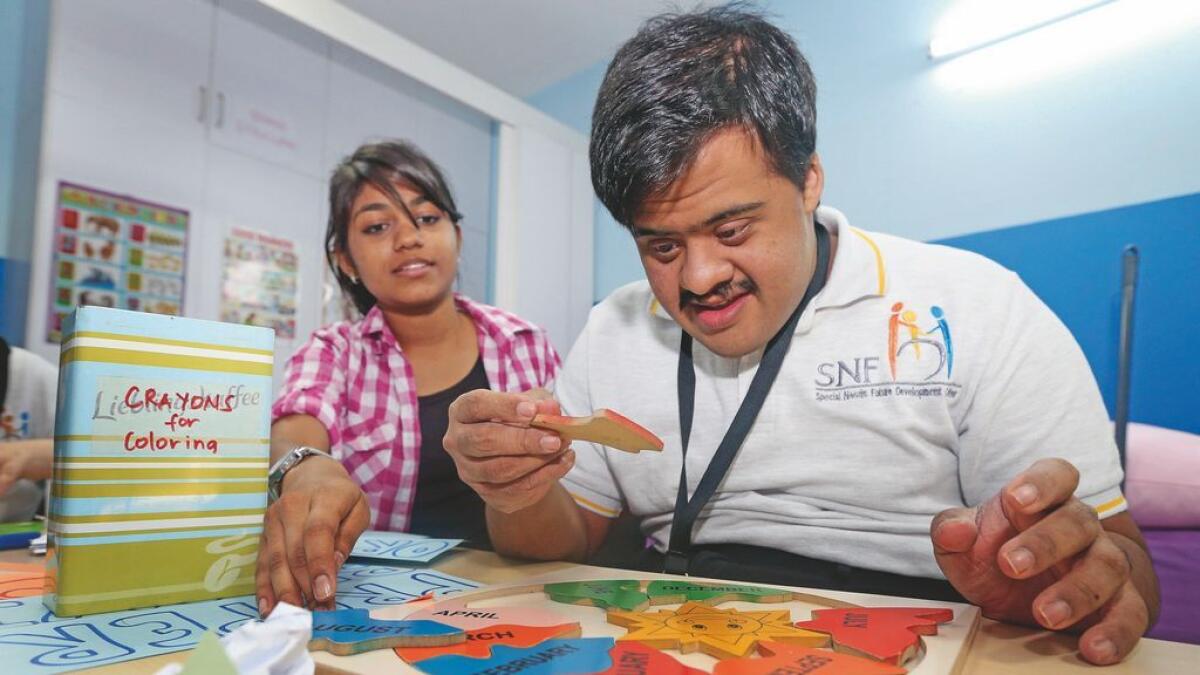 A young adult with special needs enagaged in an activity at the SNF Children Development Centre in Karama, Dubai. The centre was opened in 2007 with one room.