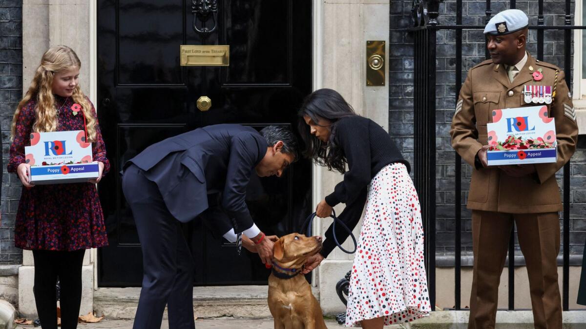 British Prime Minister Rishi Sunak and his wife Akshata Murty tend to their dog Nova. — Reuters file