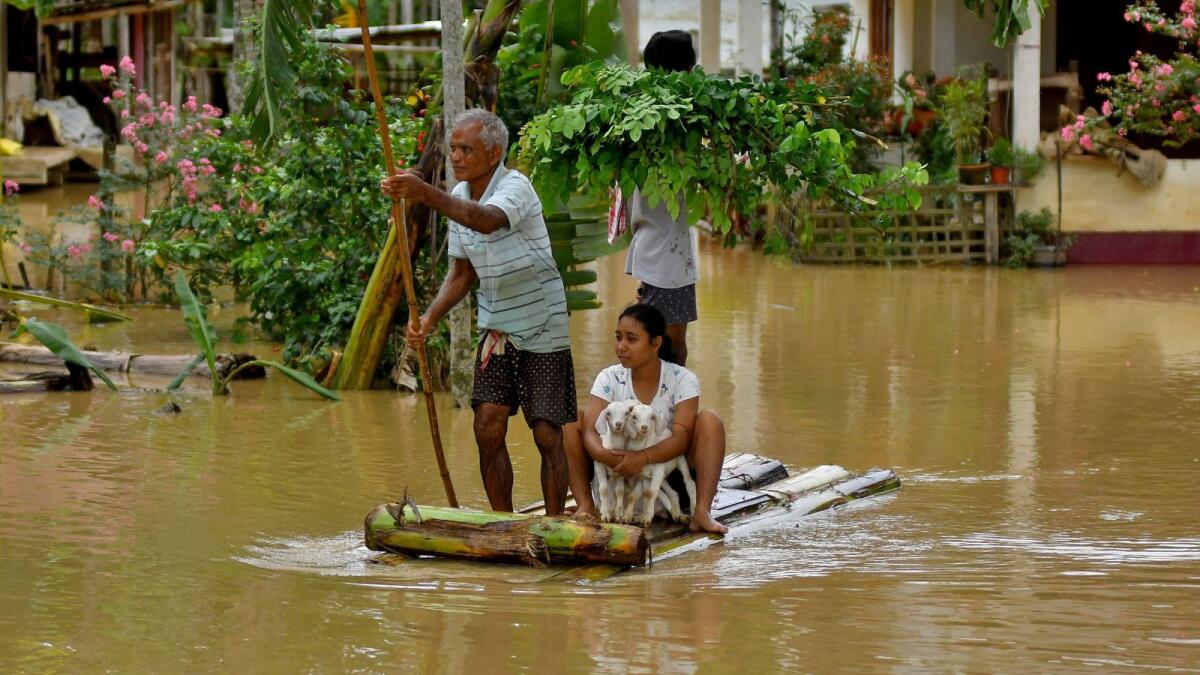 Flood-affected people use a makeshift raft to shift to a safer place following heavy rain in Nagaon district in the northeastern state of Assam, India, on Wednesday. REUTERS