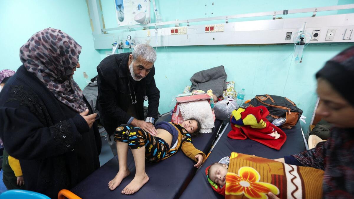 Palestinian doctor Said Abdulrahman Marouf, who was detained by Israel for 45 days and released on Thursday, February 1, examines patients at Abu Yousef Al-Najjar Hospital in Rafah, in the southern Gaza Strip. Photo: Reuters