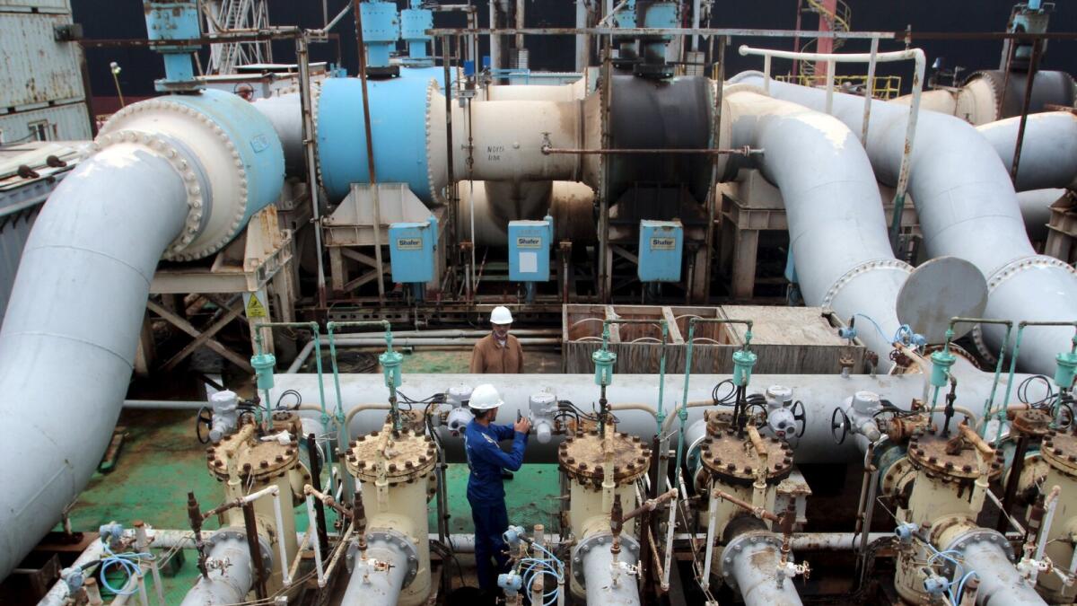 An oil worker turns a valve at the Al Basra terminal in southern Iraq. More than 18 months after oil prices began a steep slide due to excess supply, Saudi Arabia, Qatar, Venezuela and non-Opec Russia agreed last month to freeze output at January levels i