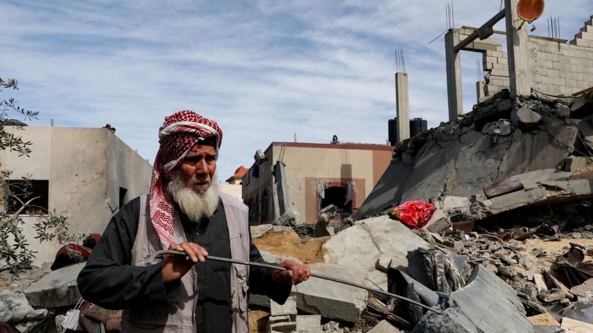A Palestinian stands at the site of an Israeli strike on a house in Rafah. — Reuters
