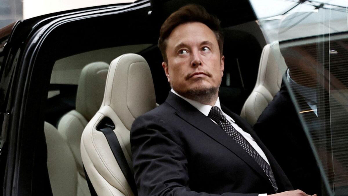 Elon Musk gets in a Tesla car as he leaves a hotel in Beijing in 2023. — Reuters file