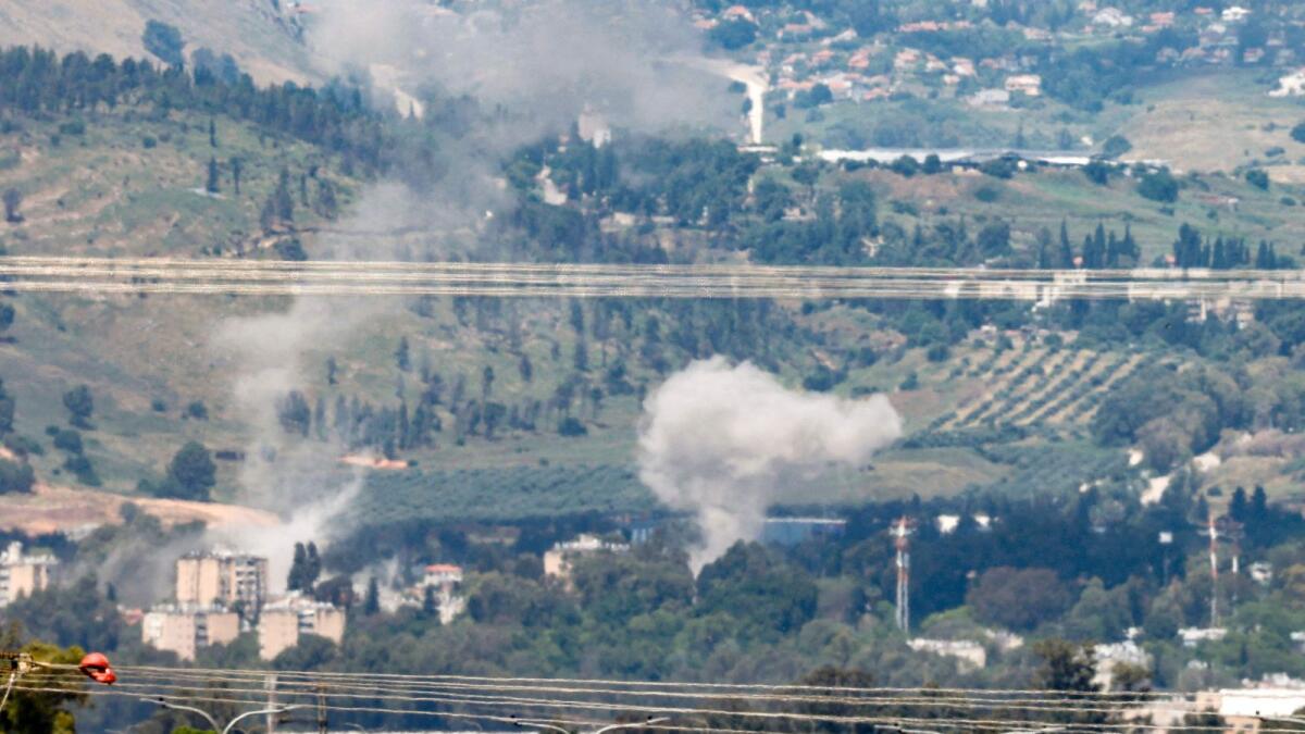 Smoke rises in the northern Israeli northern border city of Kiryat Shmona after rockets were fired from southern Lebanon. — AFP