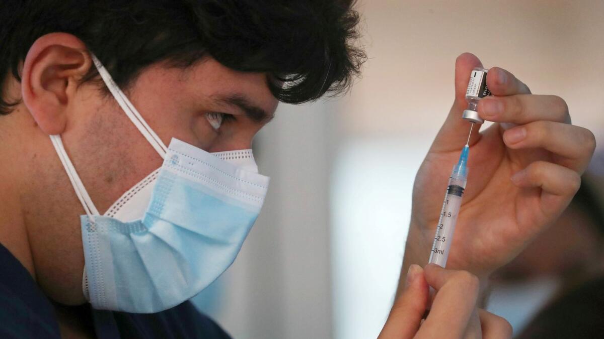 A healthcare worker prepares a dose of the Pfizer/BioNtech vaccine against the coronavirus disease (COVID-19) at the Posta Central hospital in Santiago, Chile December 24, 2020.