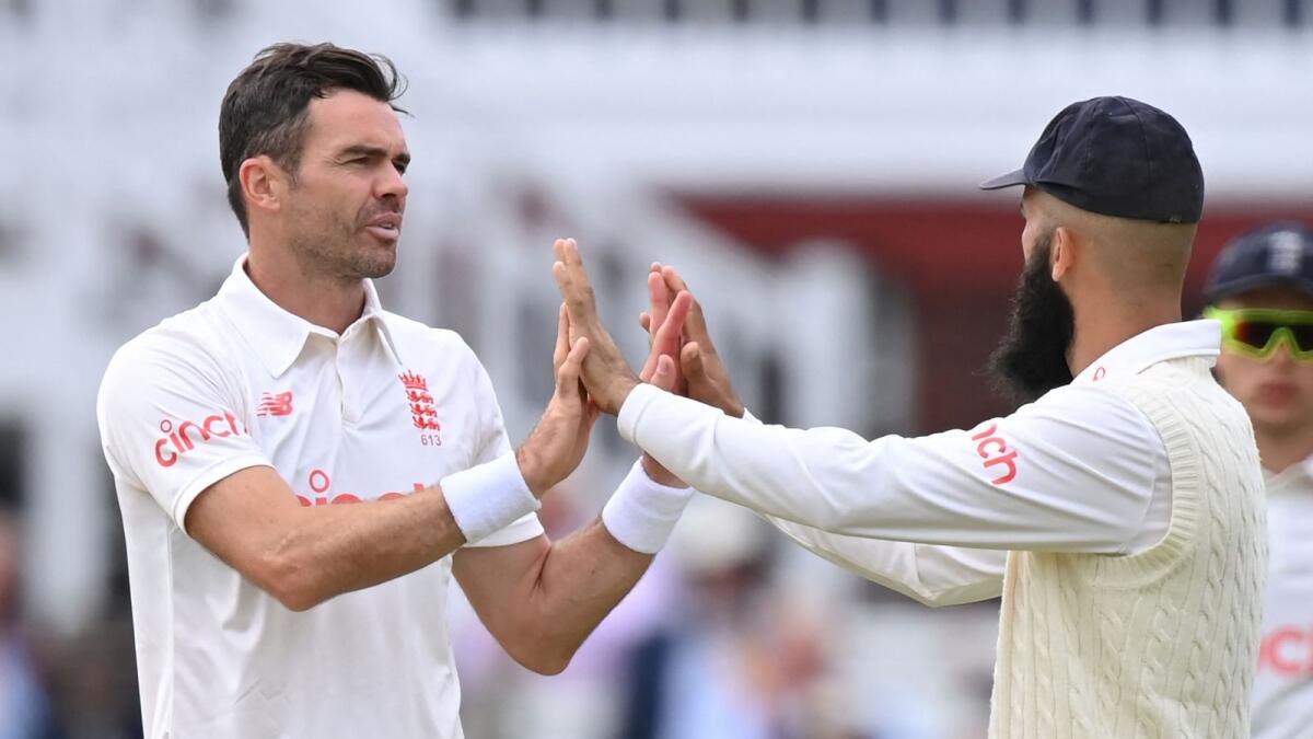 England's James Anderson (left) celebrates the wicket of India's Ishant Sharma on the second day of the second Test against India. — AFP