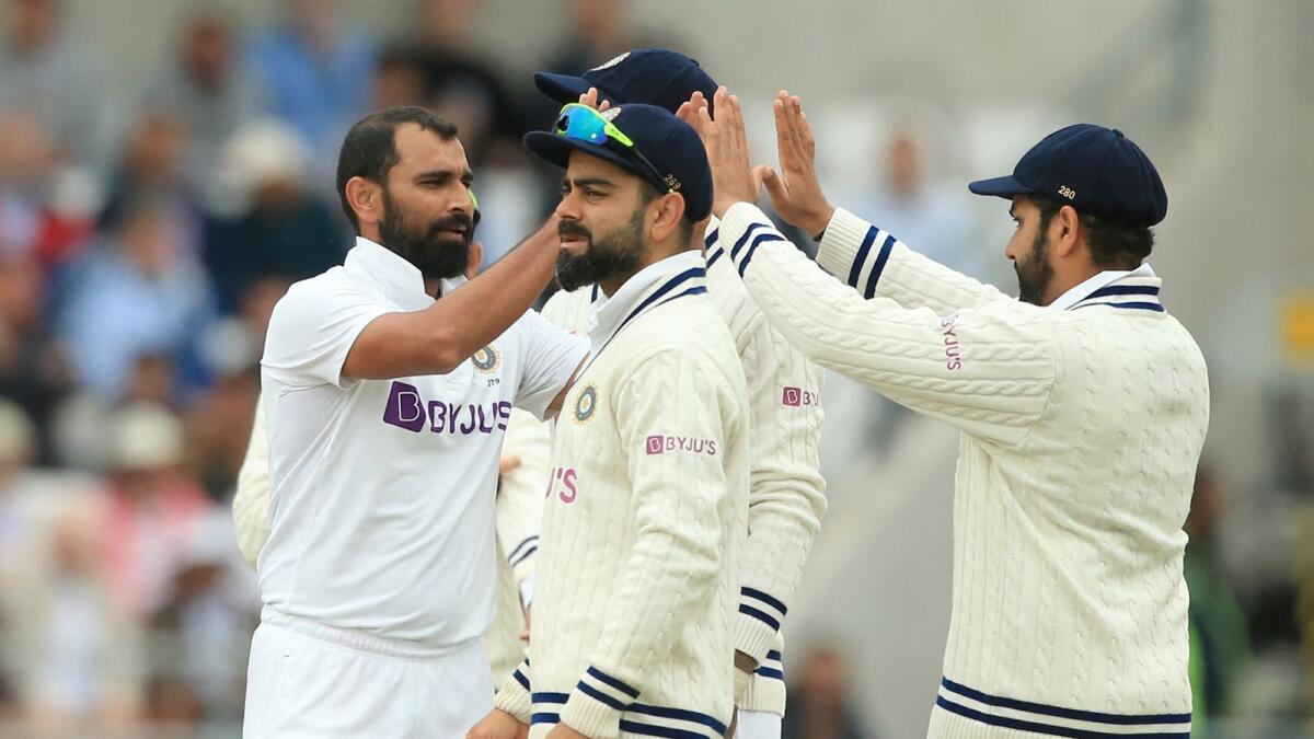 India's Mohammed Shami (left) celebrates with teammates after taking the wicket of England's Craig Overton. (AFP)
