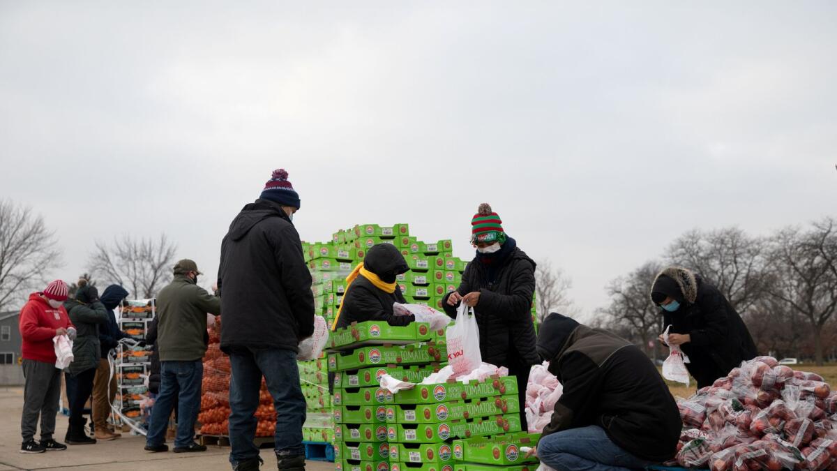 Volunteers from Forgotten Harvest food bank sort and separate different goods before a mobile pantry distribution ahead of Christmas, amid the coronavirus disease pandemic in Warren, Michigan, US.