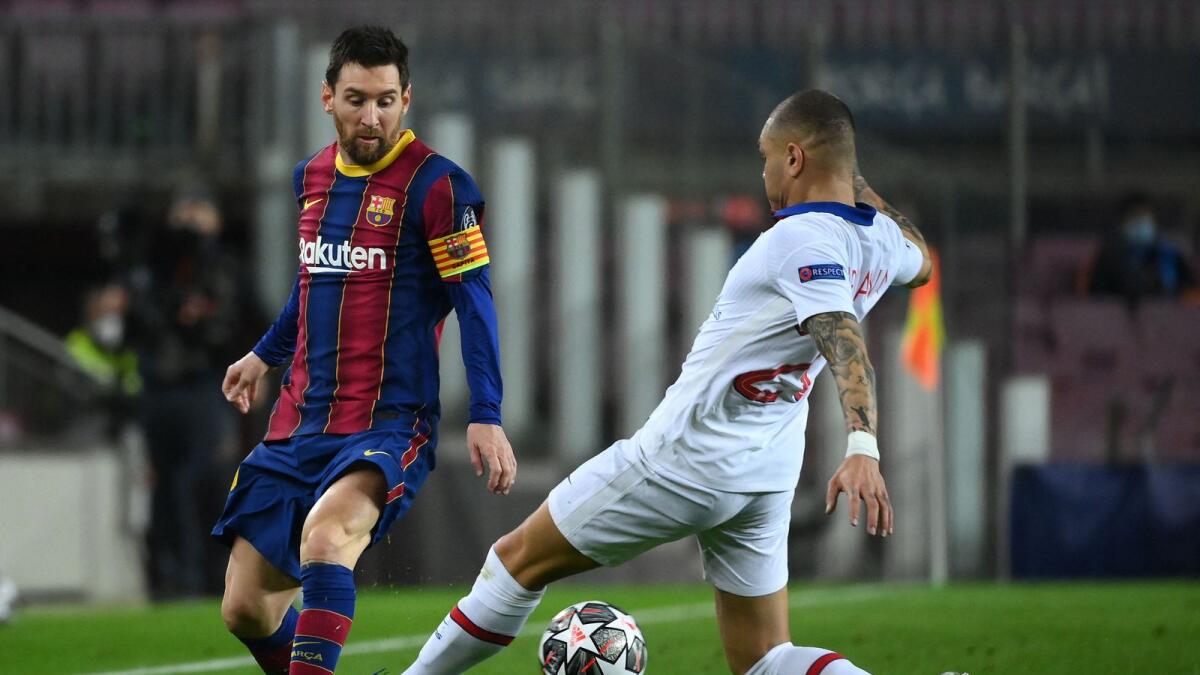Barcelona's Argentinian forward Lionel Messi (left) challenges Paris Saint-Germain's French defender Layvin Kurzawa. (AFP)