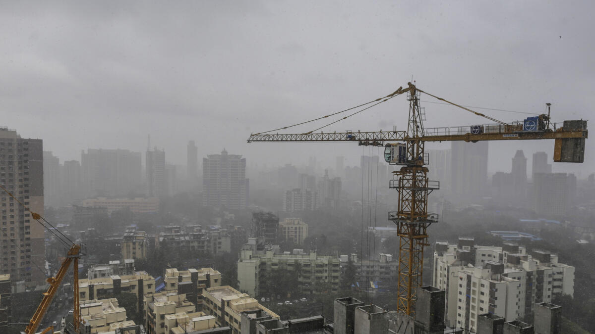 A tower crane operates at a residential construction site in Mumbai, India. — File photo