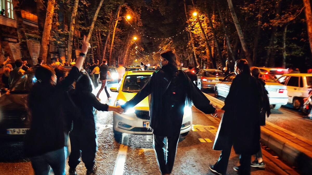 Women protest the death of 22-year-old woman Mahsa Amini who was detained by the morality police in Tehran on Oct. 1, 2022 in this supplied photo. — AP file