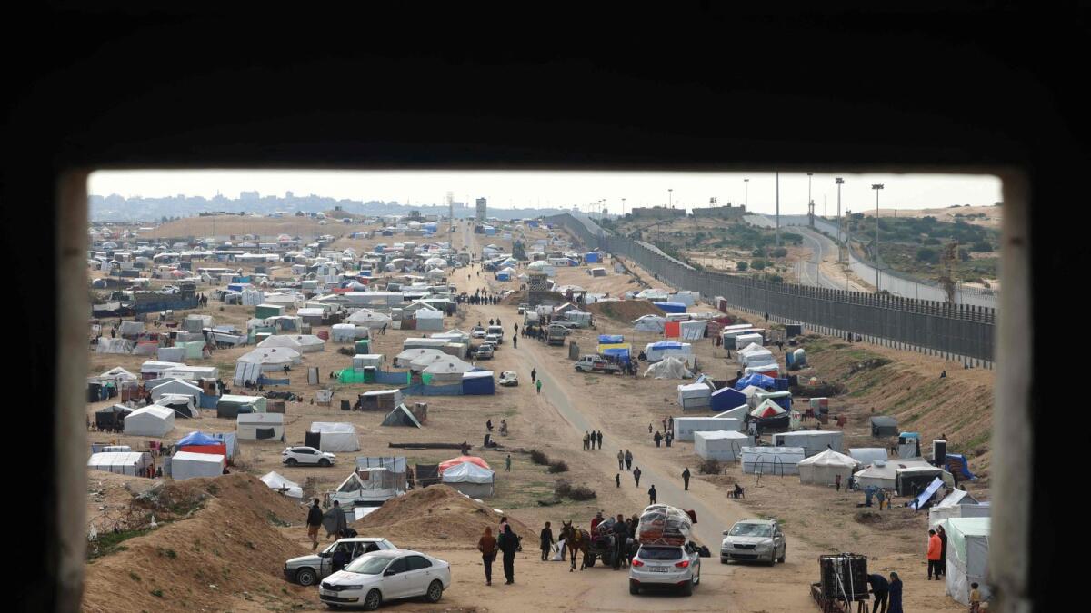 Displaced Palestinians camp near the border fence between Gaza and Egypt. — AFP