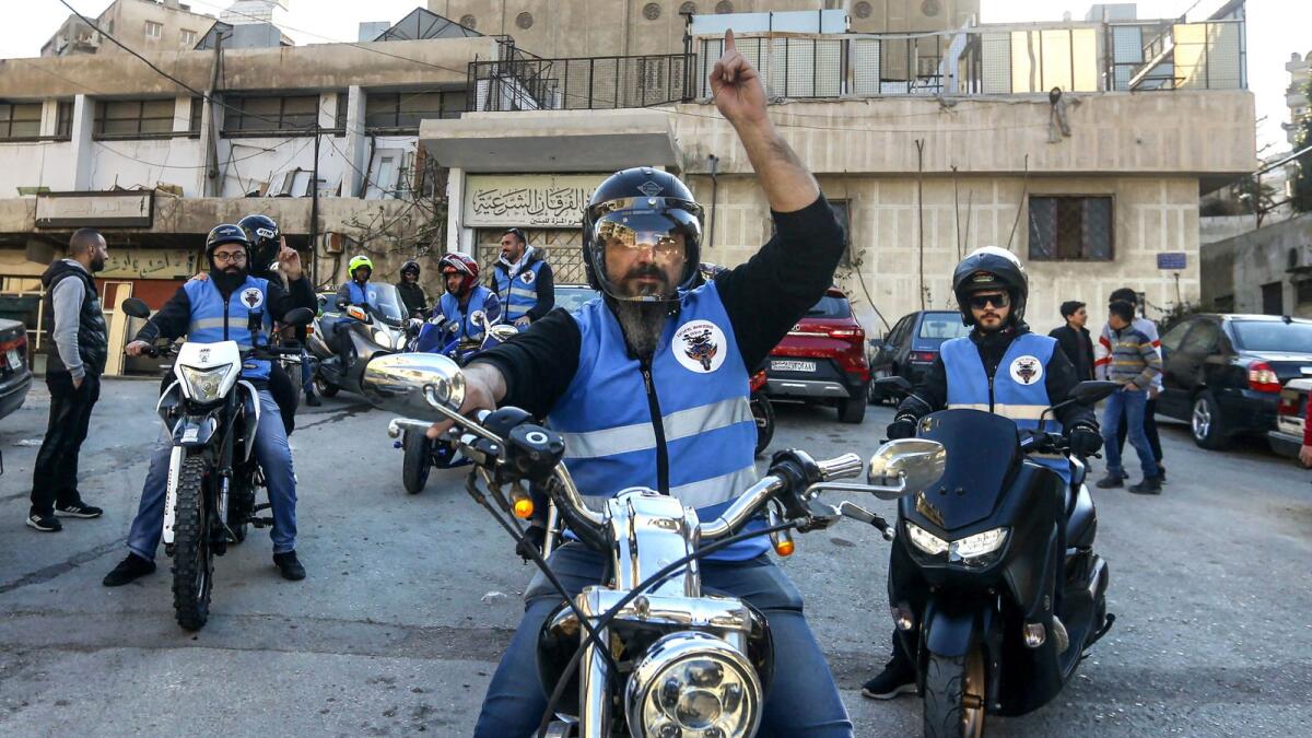Members of motorcycle club Hope Bikers Syria help distribute 'iftar' meals in Damascus. — AFP