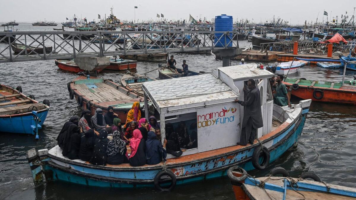 Women seeking medical consultation arrive on a boat ambulance, a free service provided by Mama Baby Fund at Baba Island along the Karachi Harbour, in Karachi. AFP