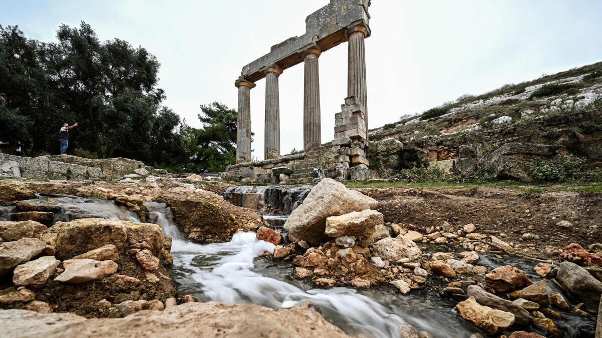 Water flows through the ruins at the site of the ancient Greco-Roman city of Cyrene (Shahhat) in eastern Libya. — AFP
