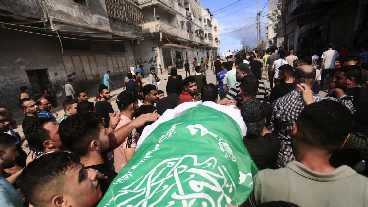 Mourners attend the funeral of a Hamas militant, who was killed by Israeli forces, on the day Hamas launched a surprise attack on Israel, in the northern Gaza Strip October 7, 2023. Reuters