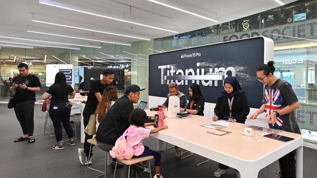 People check Apple products at a mall in Jakarta. — AFP