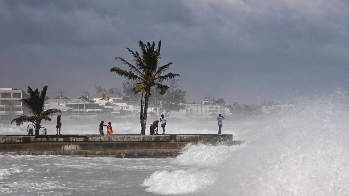 People visit a pier during a high tide after the passage of Hurricane Beryl in Oistins near Bridgetown, Barbados, on July 1, 2024. — AFP