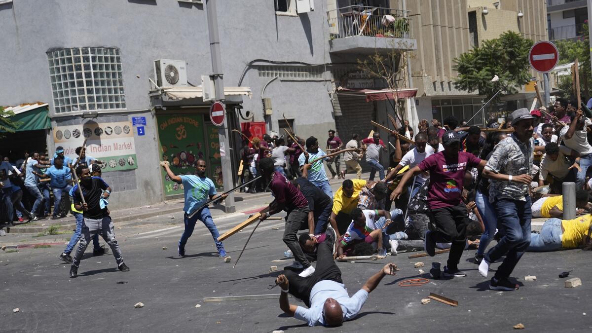 Anti-Eritrean government activists, left, clash with supporters of the Eritrean government, in Tel Aviv. — AP