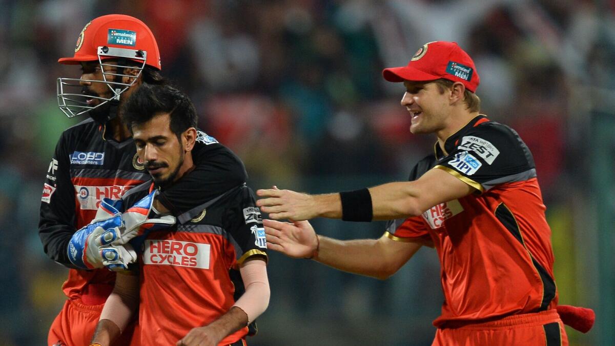 Royal Challengers Bangalore bowler Yuzvendra Chahal (2L) celebrates with wicketkeeper K L Rahul (L) and teammate Shane Watson after the dismissal of Sunrisers Hyderabad batsman Shikhar Dhawan during the final Twenty20 cricket match of the 2016 Indian Premier League (IPL) between Royal Challengers Bangalore and Sunrisers Hyderabad at The M. Chinnaswamy Stadium in Bangalore on May 29, 2016.  AFP